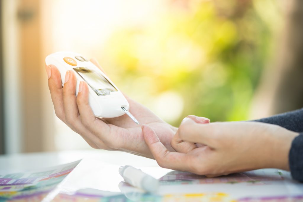 person checking their blood sugar level for diabetes