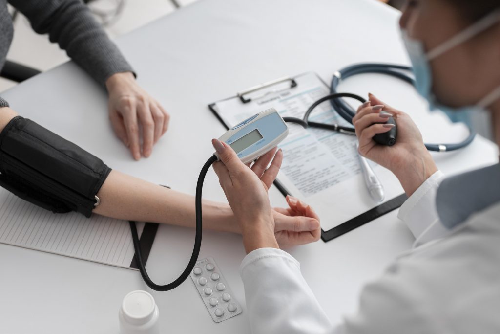 doctor checking a patient's blood pressure