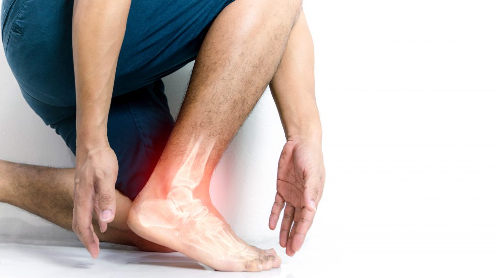 man having arthritis joint pain in his ankle